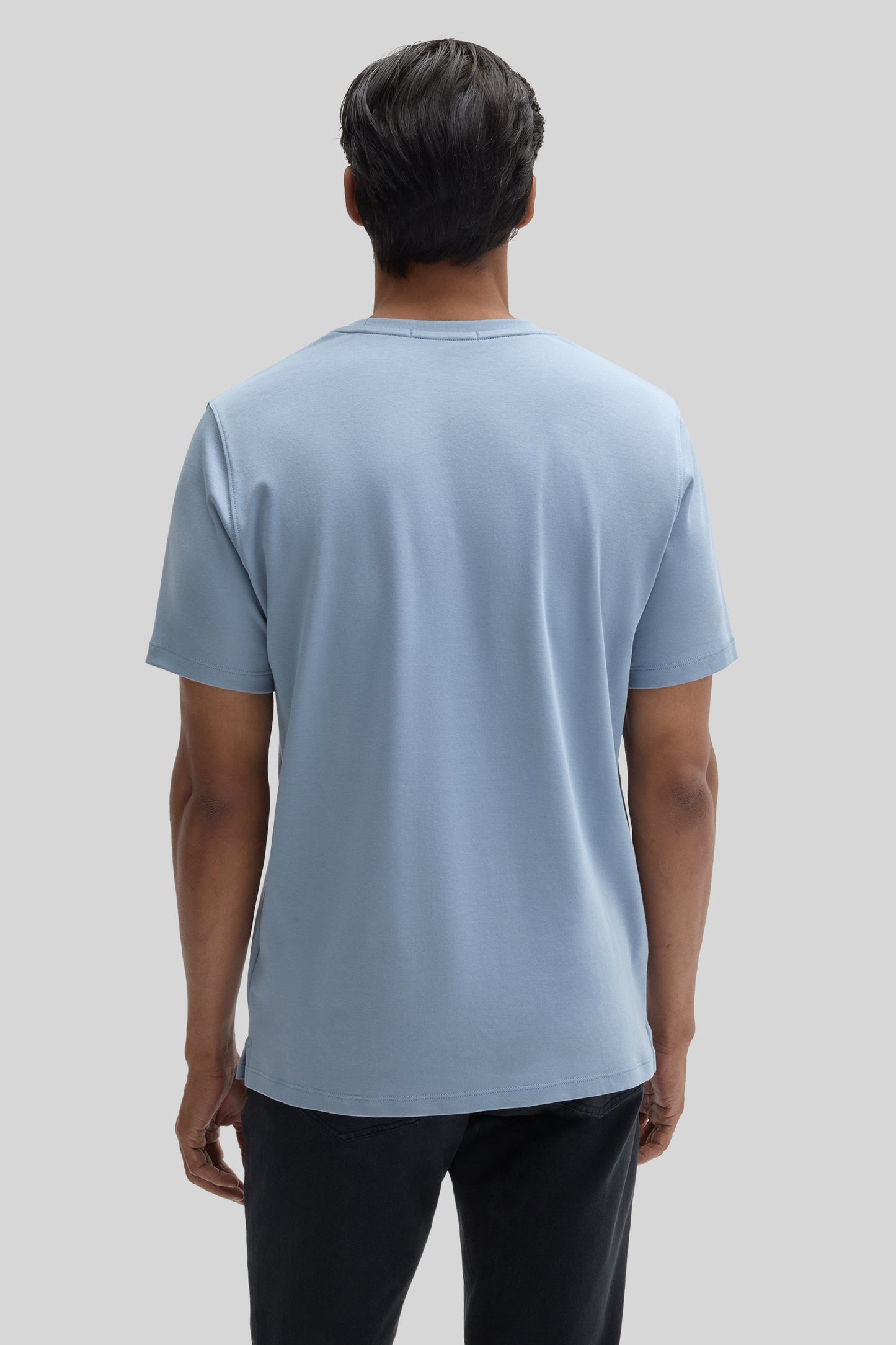 Man wearing light blue short-sleeve crew neck t-shirt, back view.