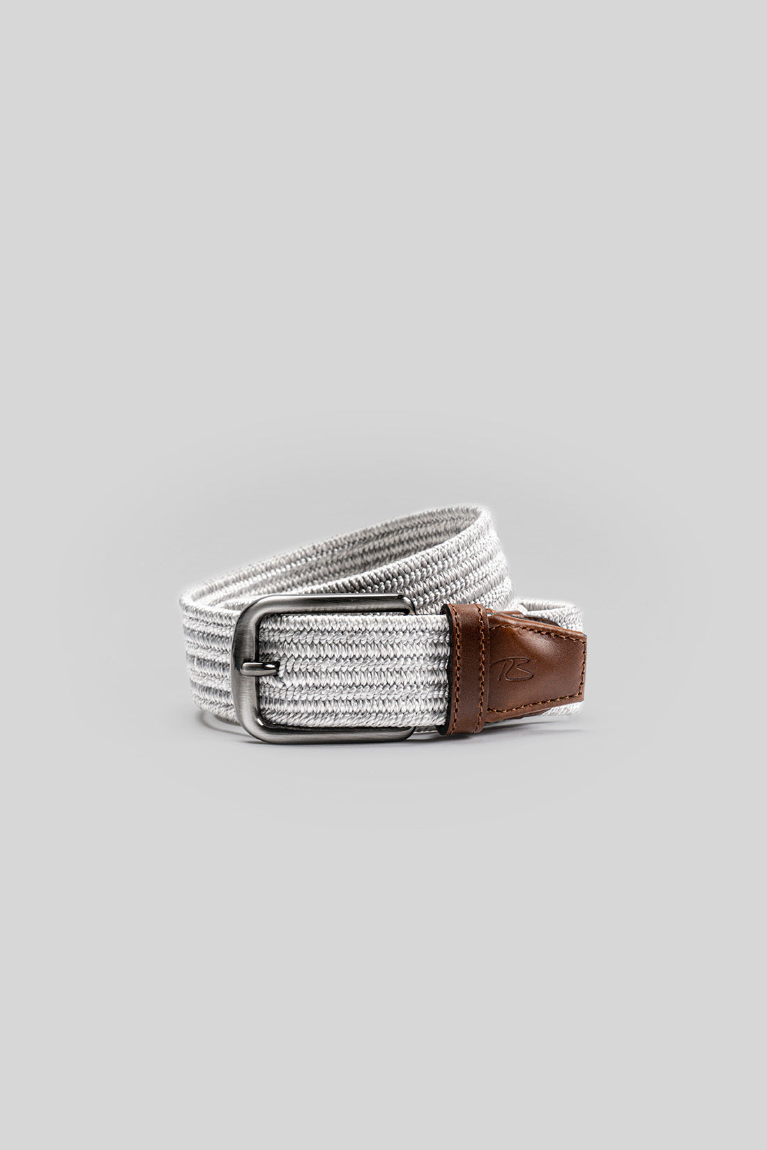 White woven fabric belt with brown leather end tab and silver metal buckle.