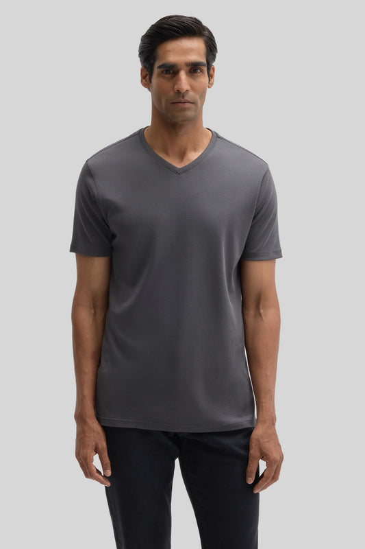 Man wearing charcoal gray V-neck short-sleeve tee with black pants.
