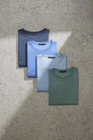 4 different color t-shirts folded laying flat