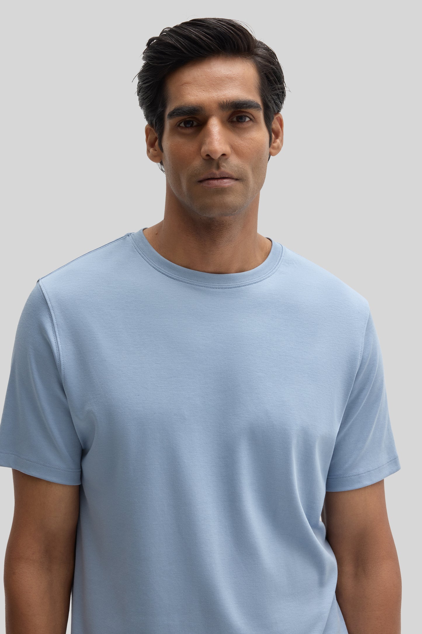 Man wearing a light blue short-sleeve crew neck t-shirt.