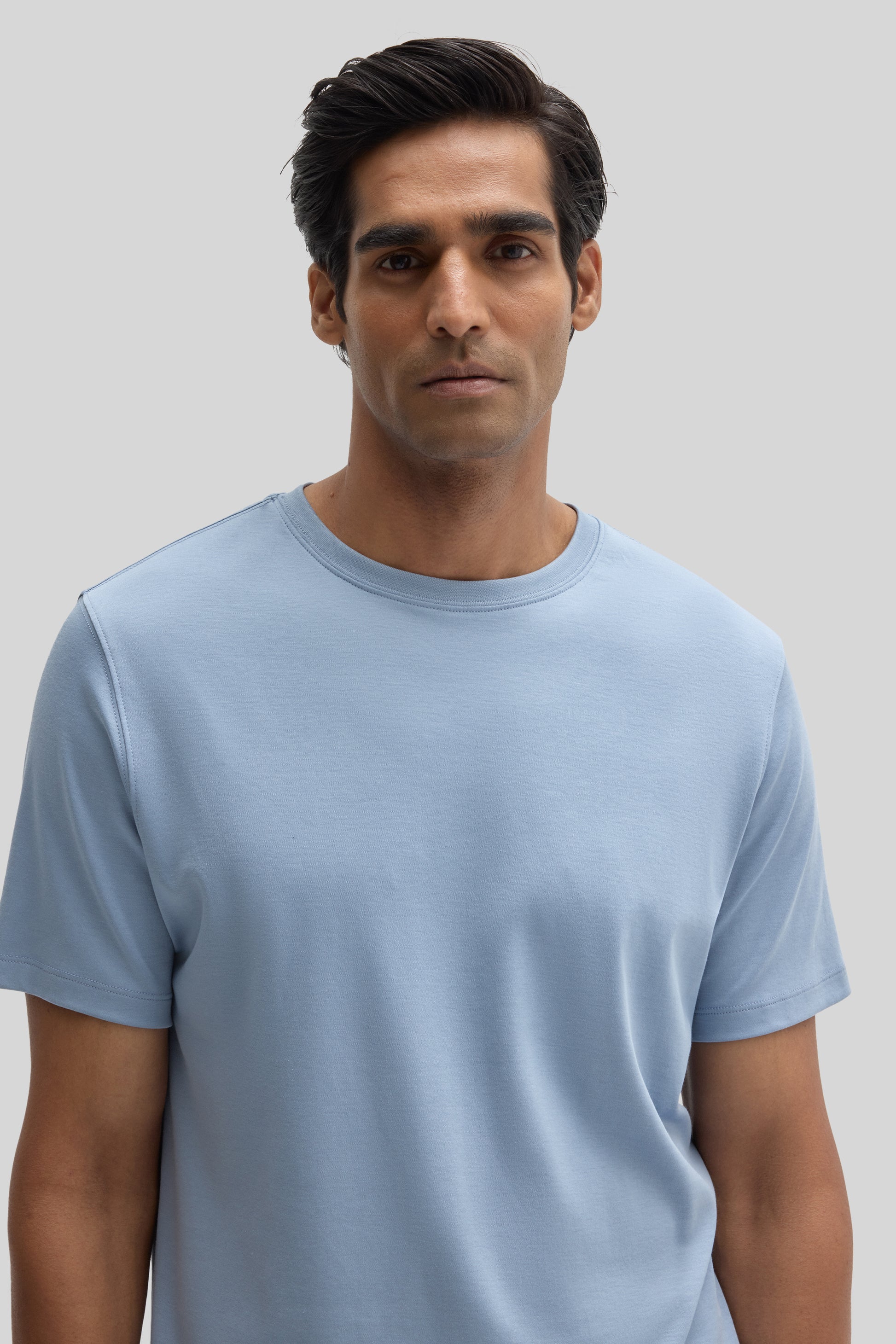 Man wearing a light blue short-sleeve crew neck t-shirt.
