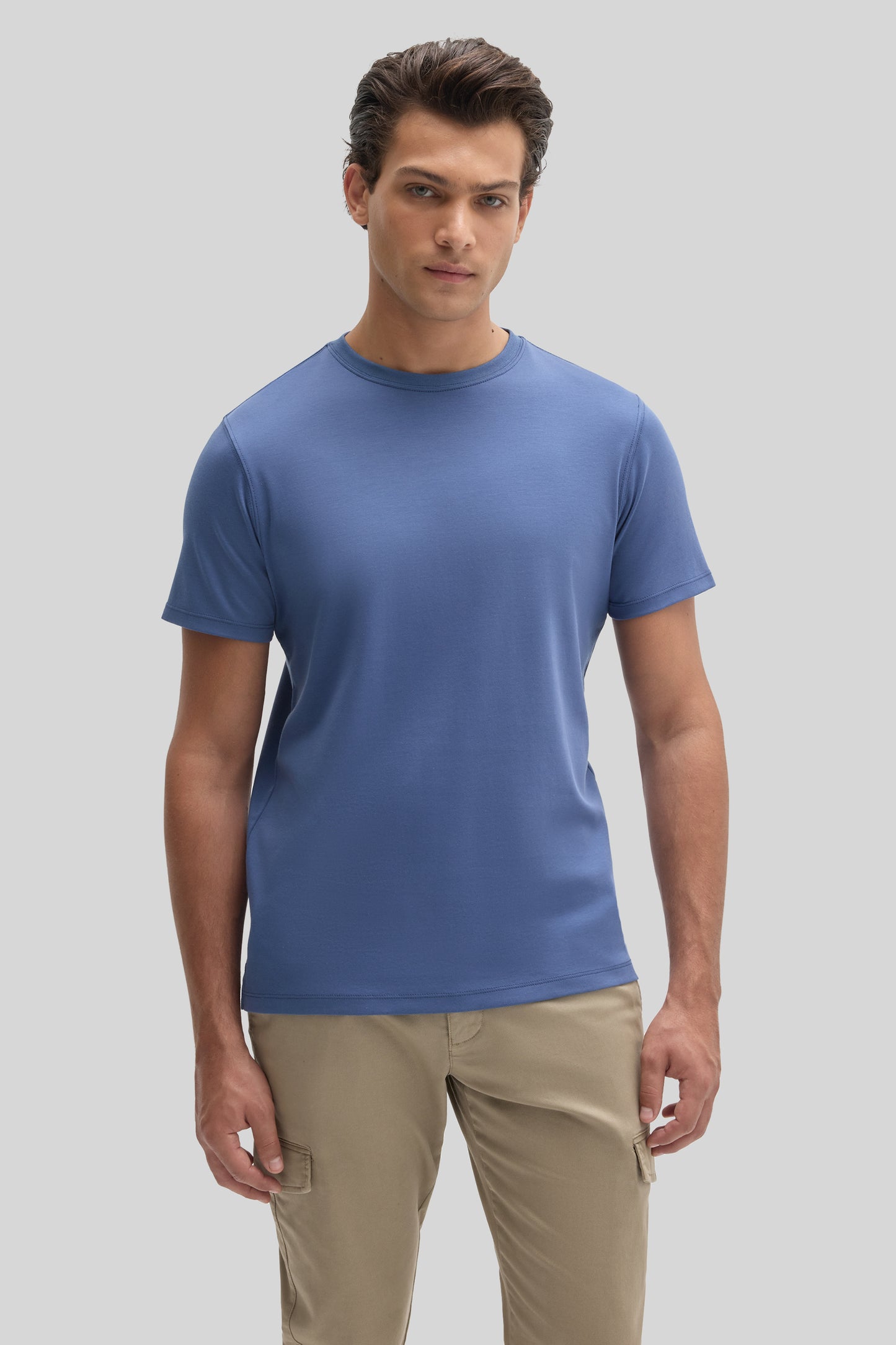 Man wearing blue crew neck short-sleeve t-shirt with tan cargo pants.