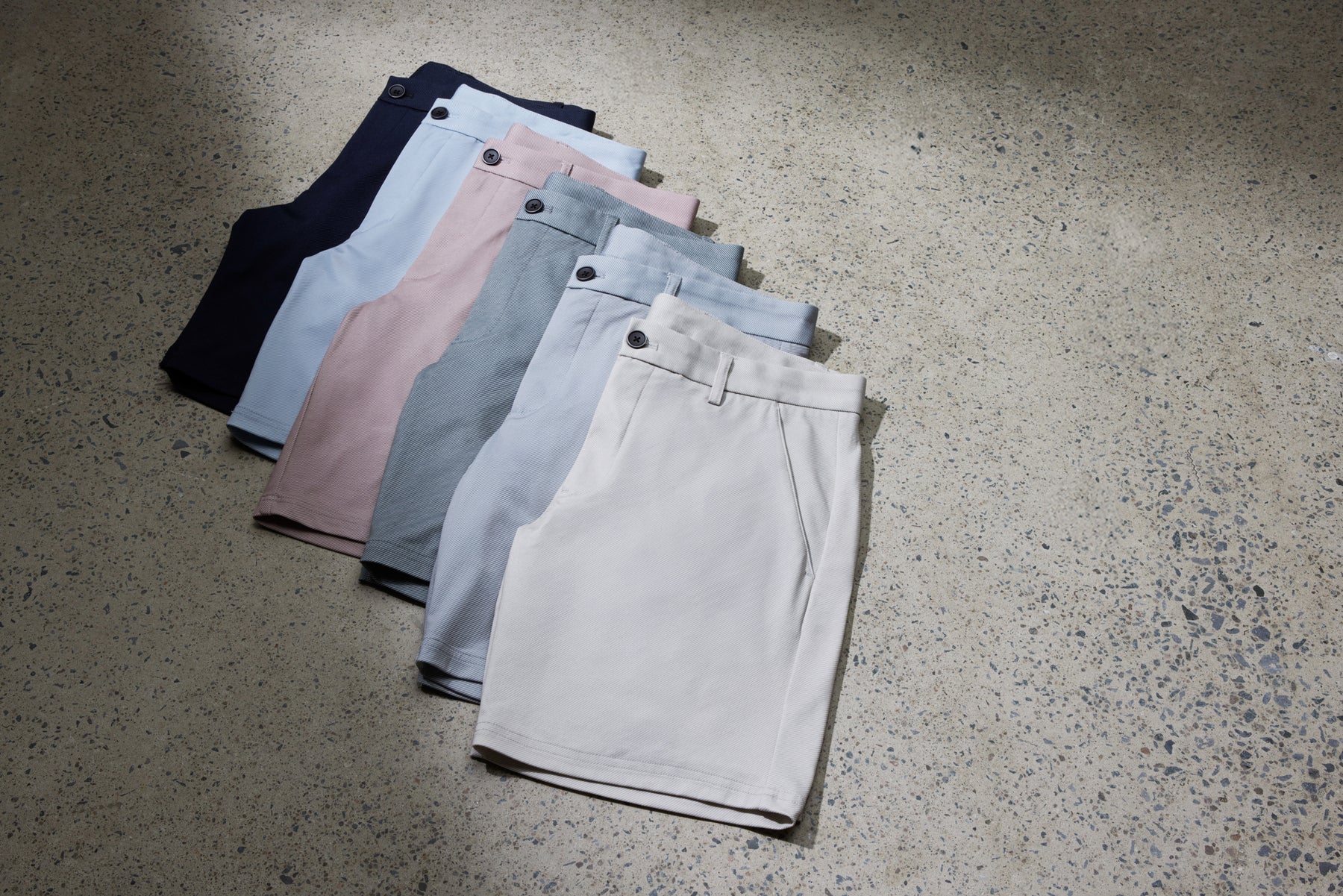 6 different color cotton shorts laying flat and folded