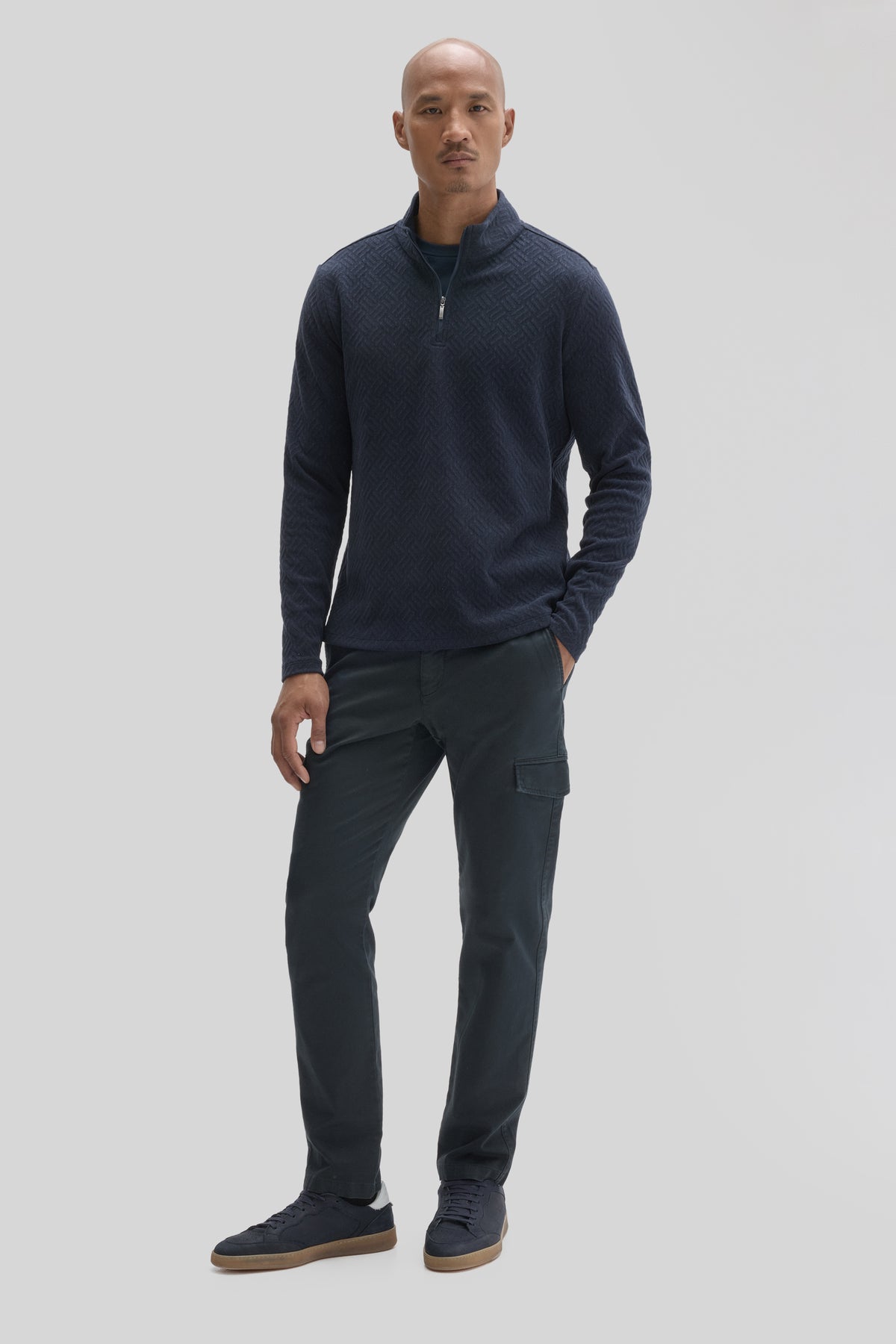 Navy long sleeve quarter zip pullover with textured knit fabric and funnel neckline, paired with charcoal cargo pants.