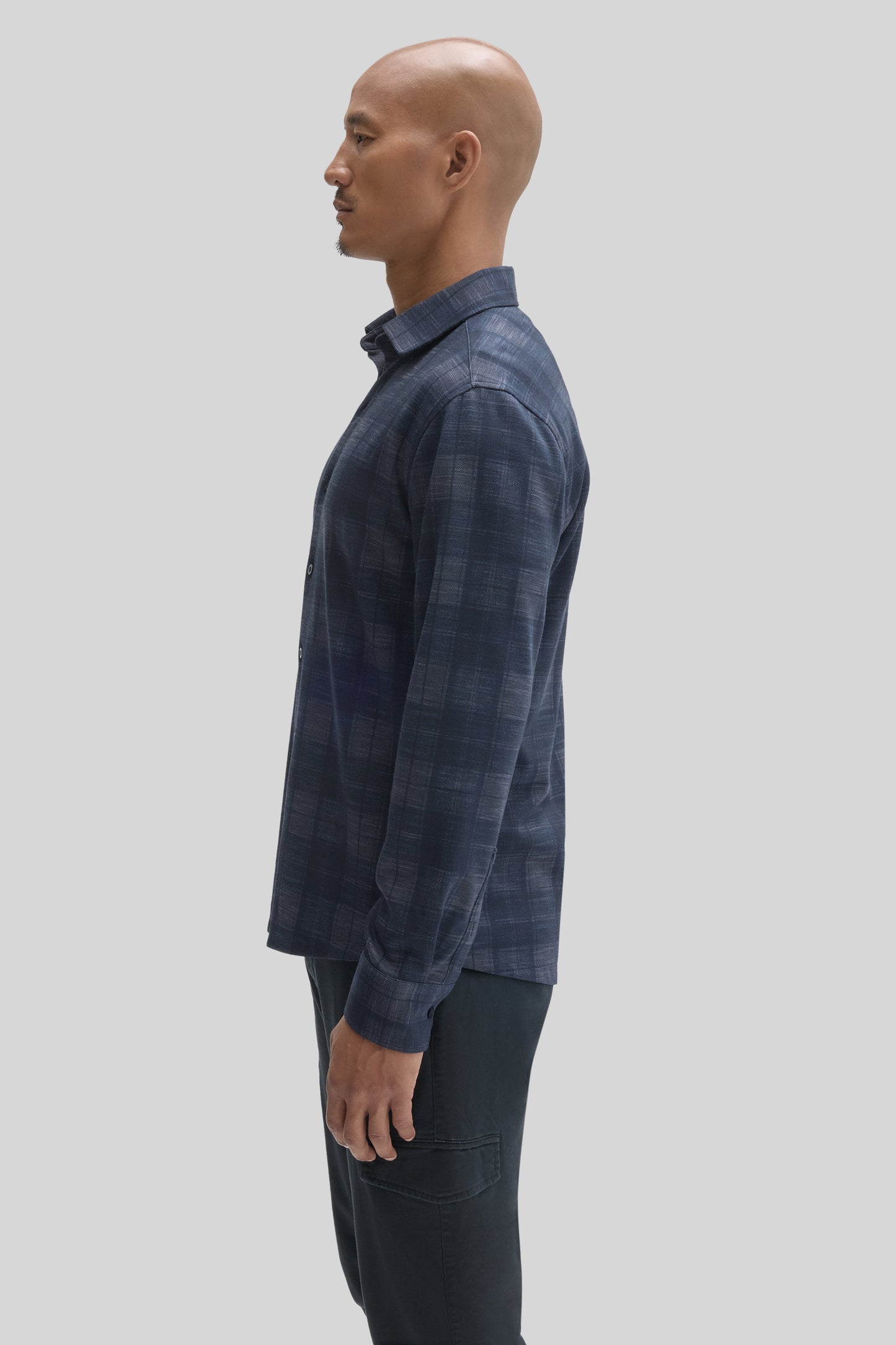 Navy blue checked knit shirt with collar on mannequin, shown in side profile view.