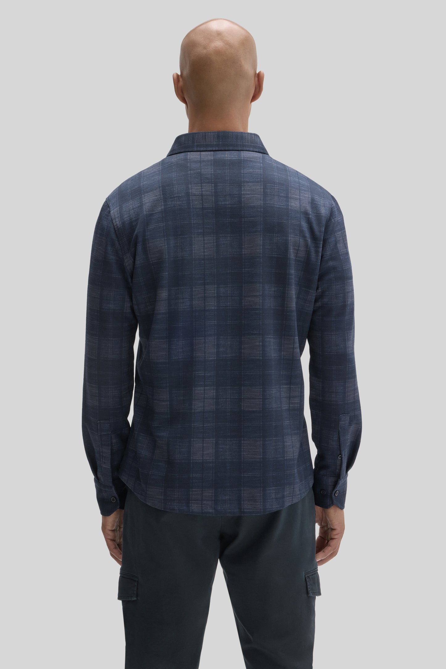 Navy blue plaid knit shirt with long sleeves and collar, shown from back view on model.
