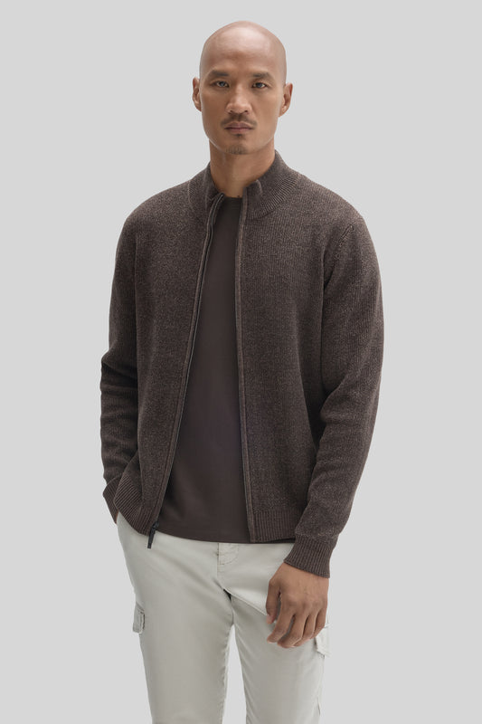 Man wearing charcoal mock neck full zip sweater over black shirt with cream cargo pants.