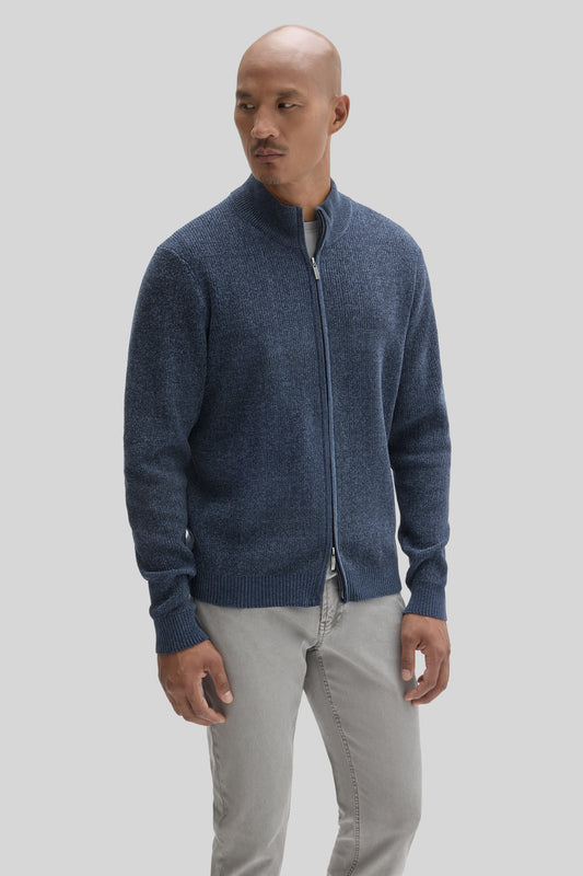 Man wearing navy blue full zip mock neck sweater with ribbed texture over gray pants.