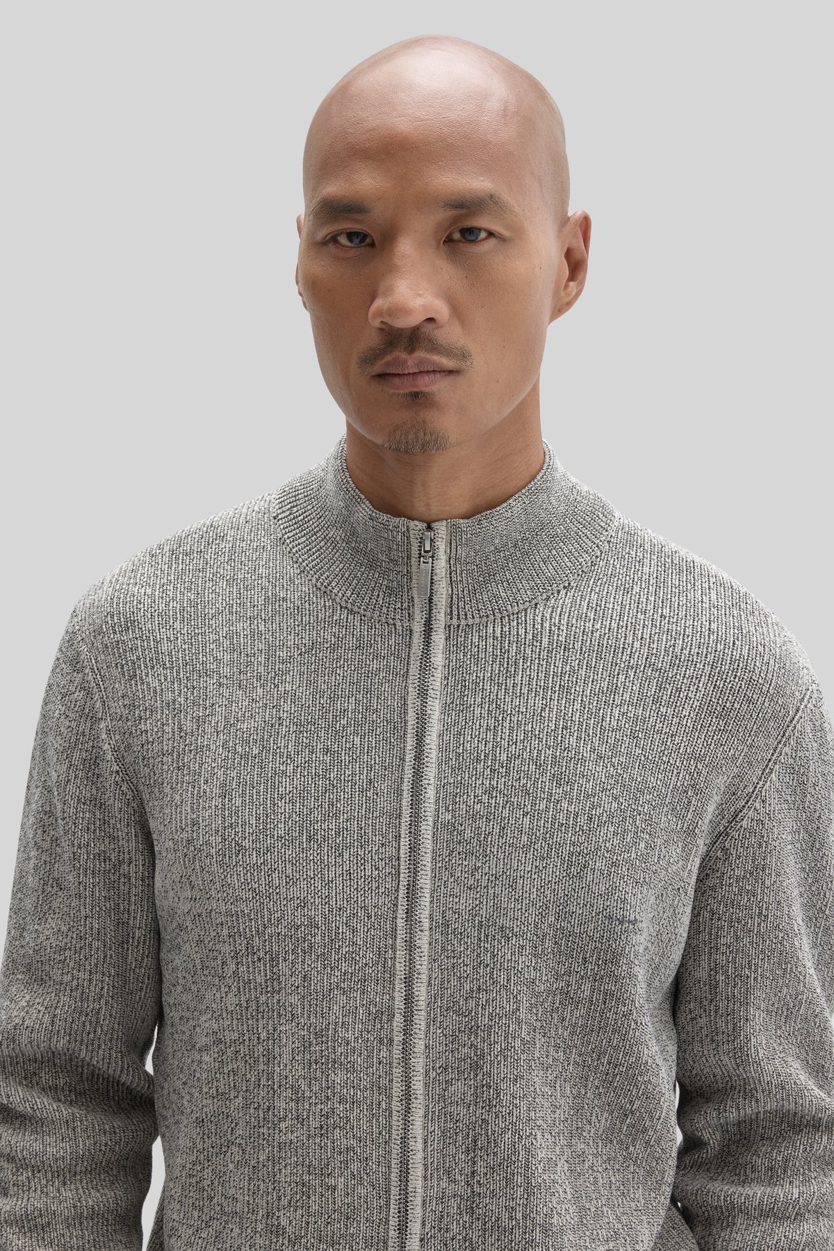 Gray ribbed mock neck sweater with full zip closure.