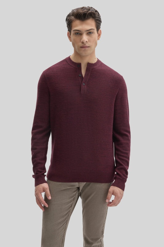 Burgundy henley sweater with three-button placket and ribbed cuffs worn with khaki pants.