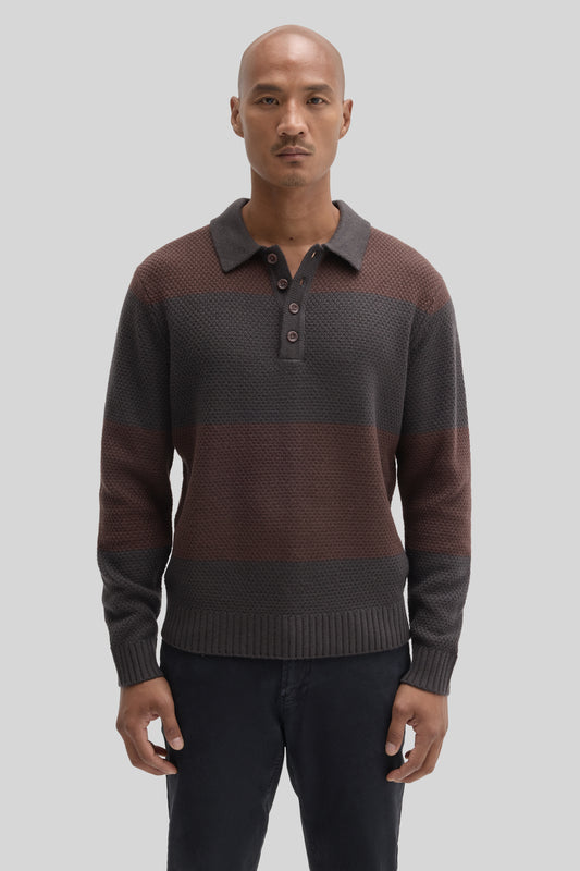 Men's rugby polo sweater in charcoal and burgundy color-block knit with collar and button placket.