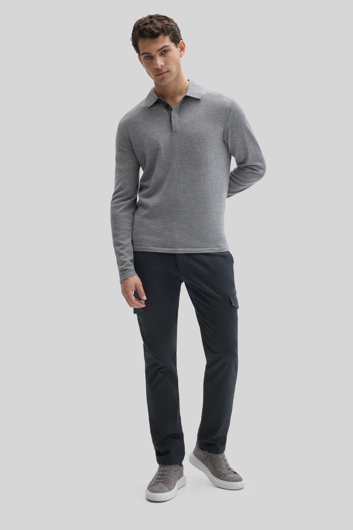 Man wearing gray long-sleeve polo sweater with collar and dark navy cargo pants.