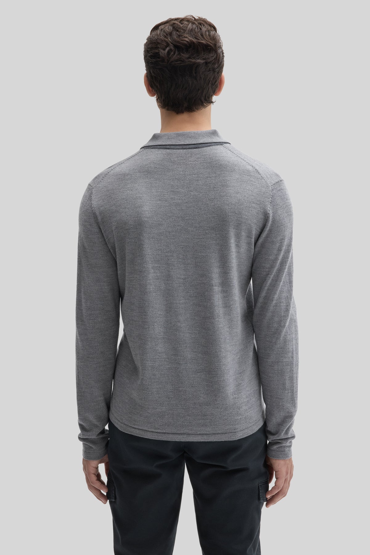 Gray long sleeve polo sweater with ribbed collar, shown from back on model wearing black pants.