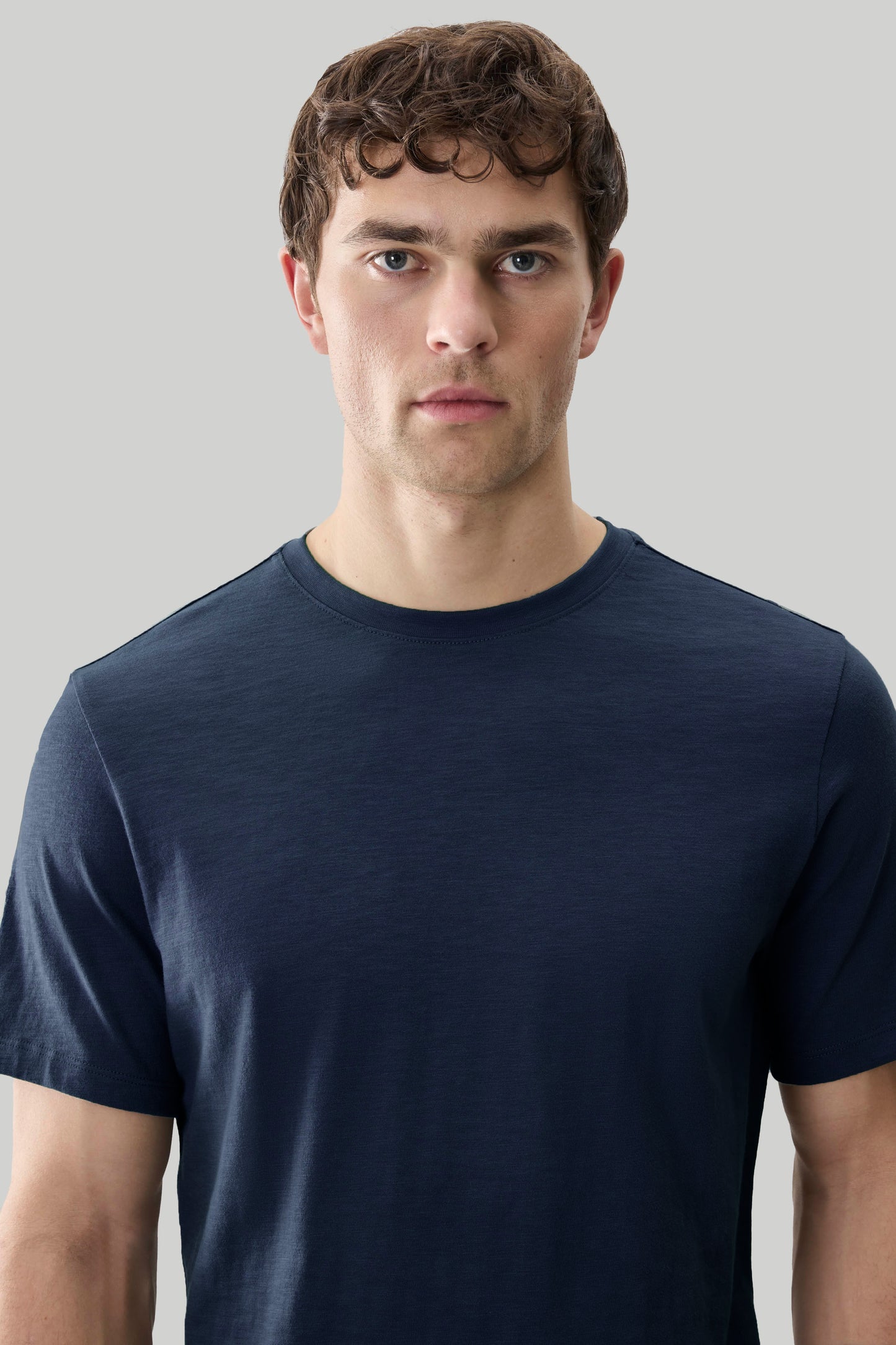 Man wearing dark navy short-sleeve crewneck tee with textured slub fabric.