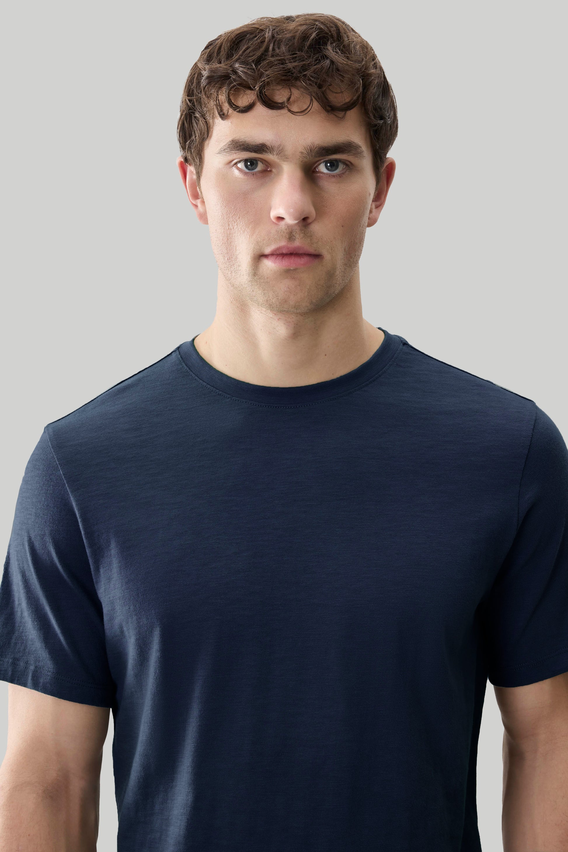Man wearing dark navy short-sleeve crewneck tee with textured slub fabric.