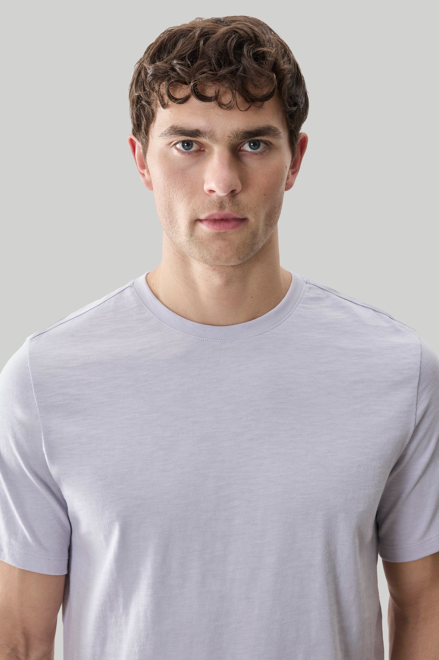 Man wearing light purple short-sleeve crew neck tee with textured slub fabric.