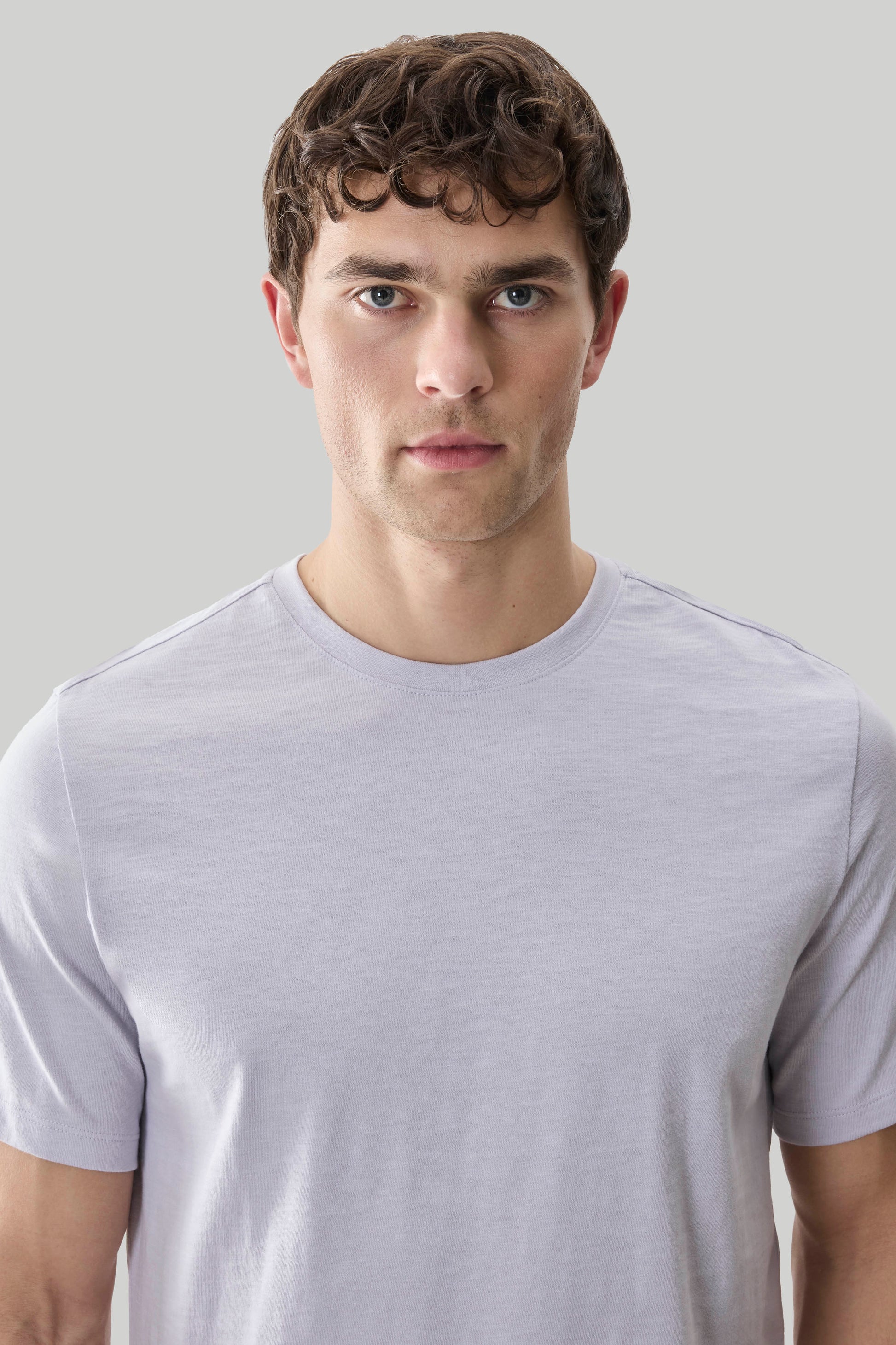 Man wearing light purple short-sleeve crew neck tee with textured slub fabric.
