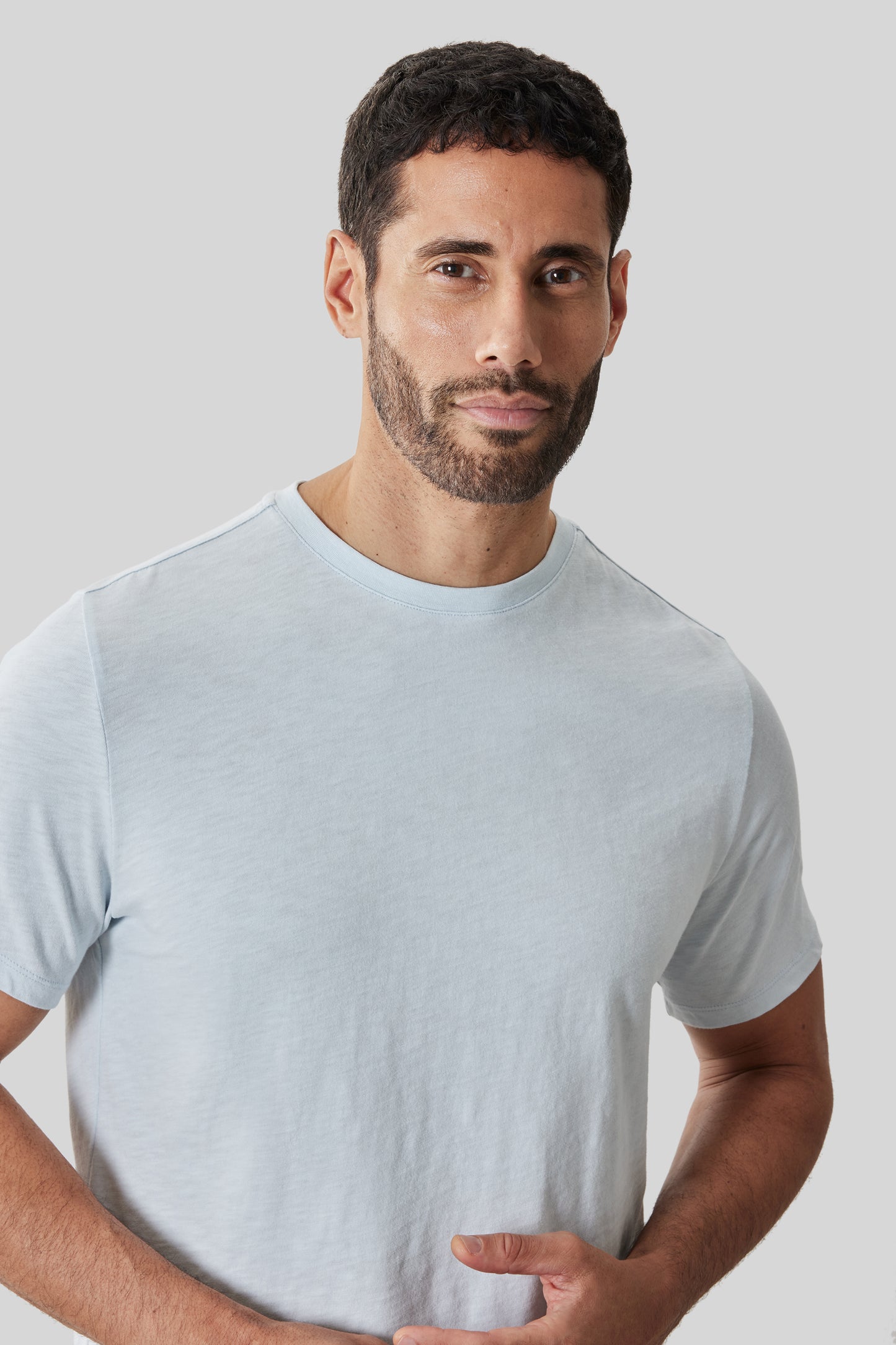 Man wearing light gray short-sleeve crew neck tee with textured slub fabric.