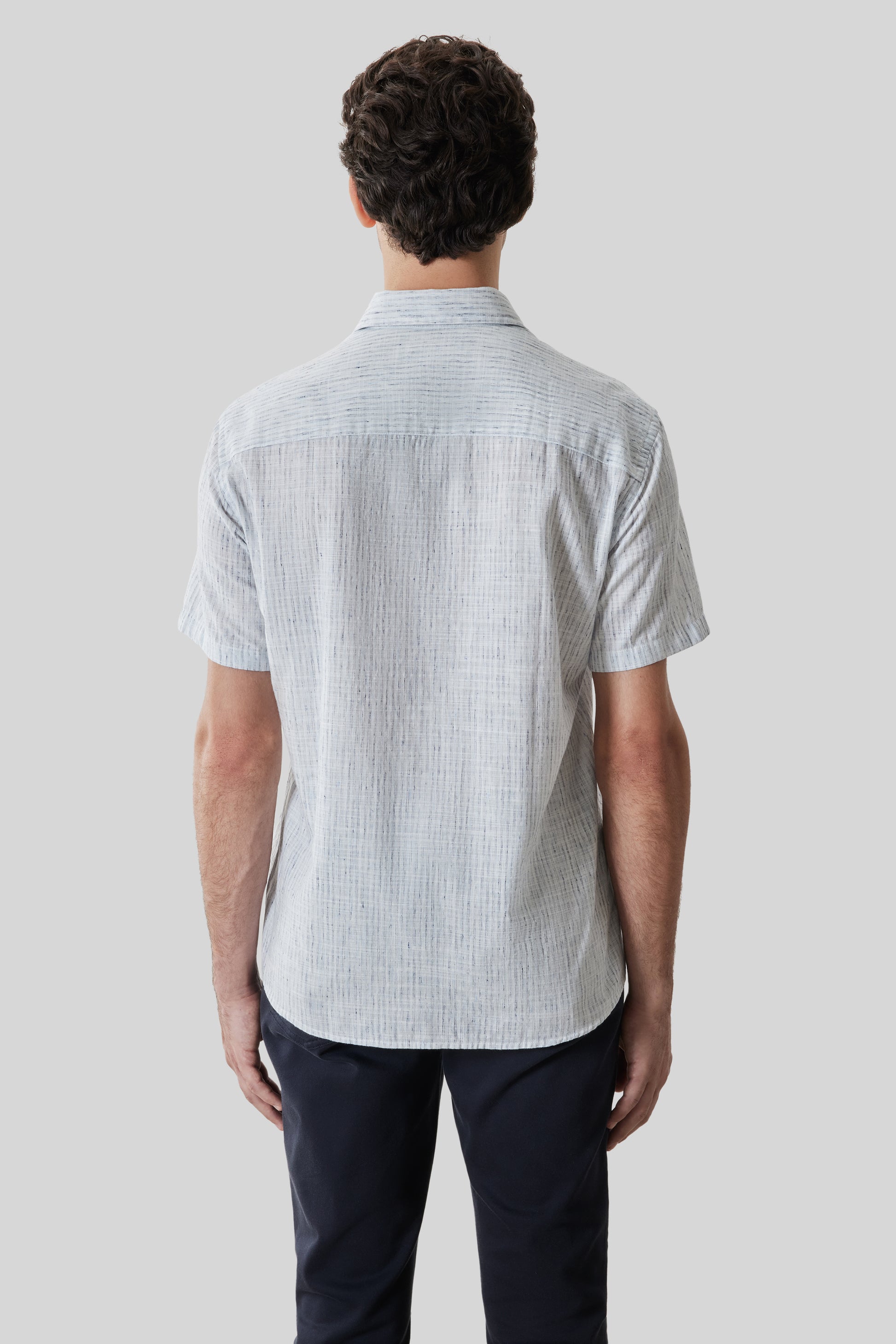 Men's short-sleeve shirt in light blue with textured striped pattern and button front closure.