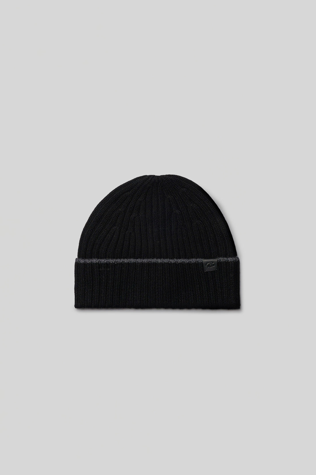 Black ribbed knit beanie with gray stripe detail and small logo patch on fold.
