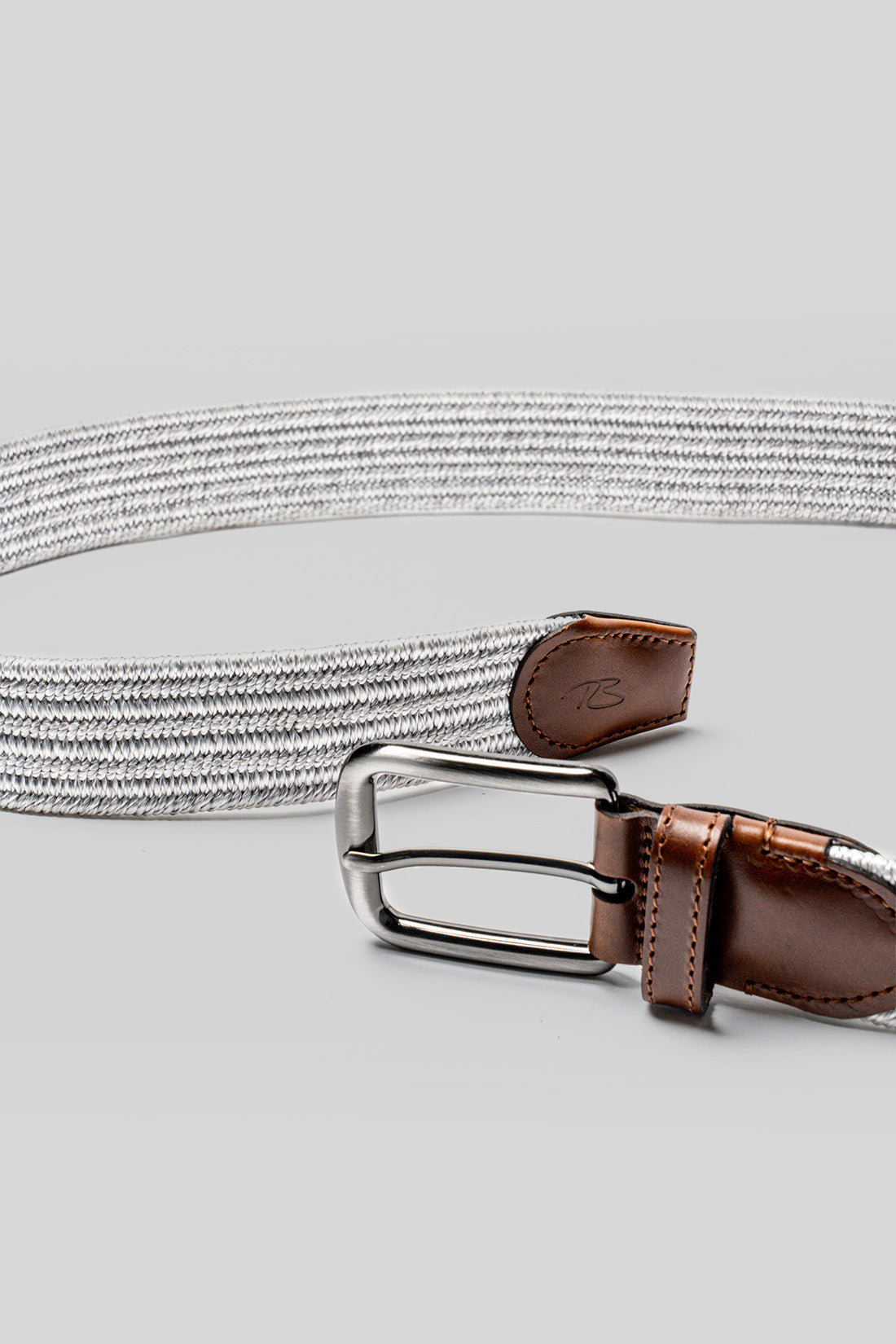 Stirling fabric belt with gray woven strap, brown leather trim, and silver rectangular buckle.