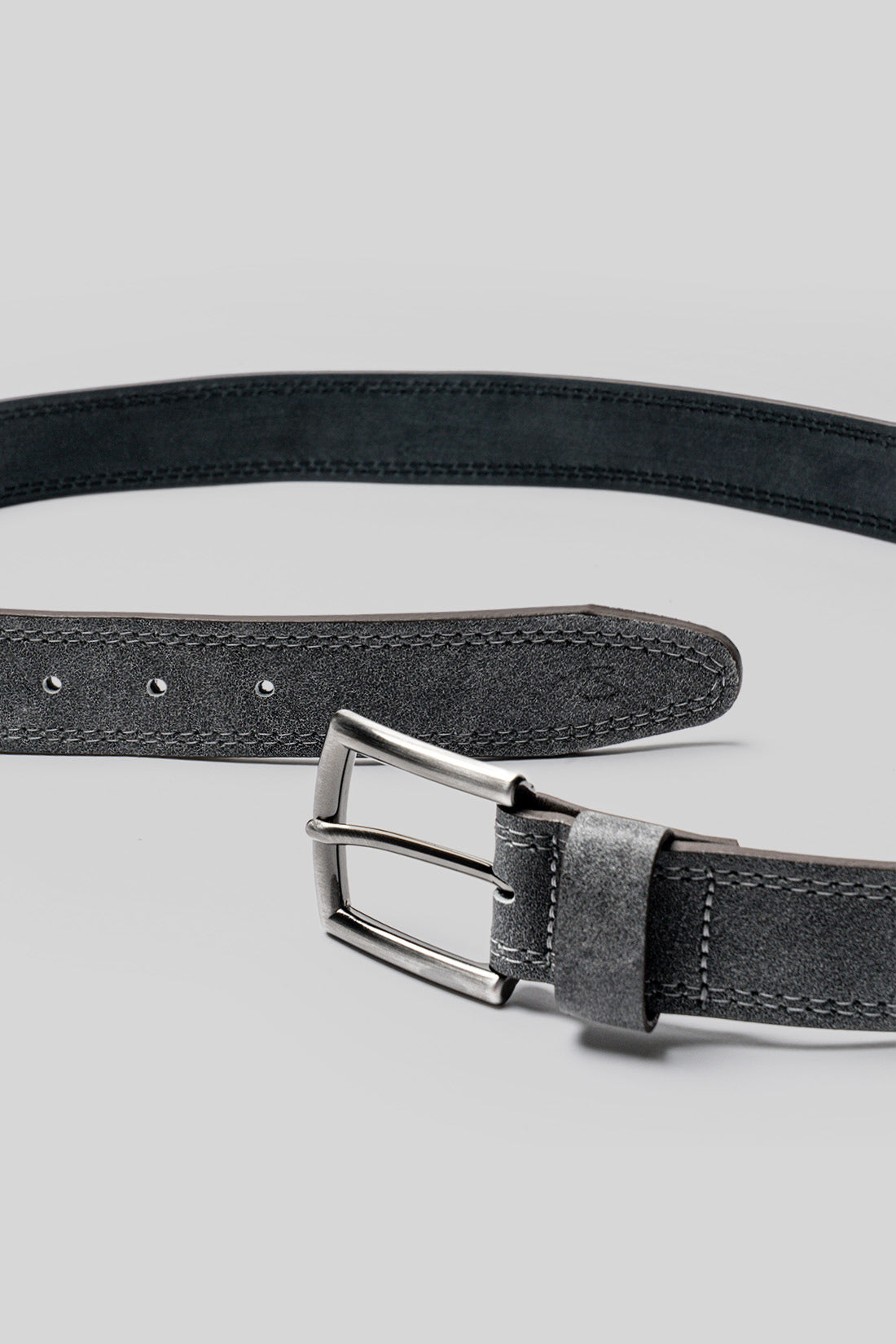 Black leather belt with rectangular metal buckle and visible stitching detail along the strap.