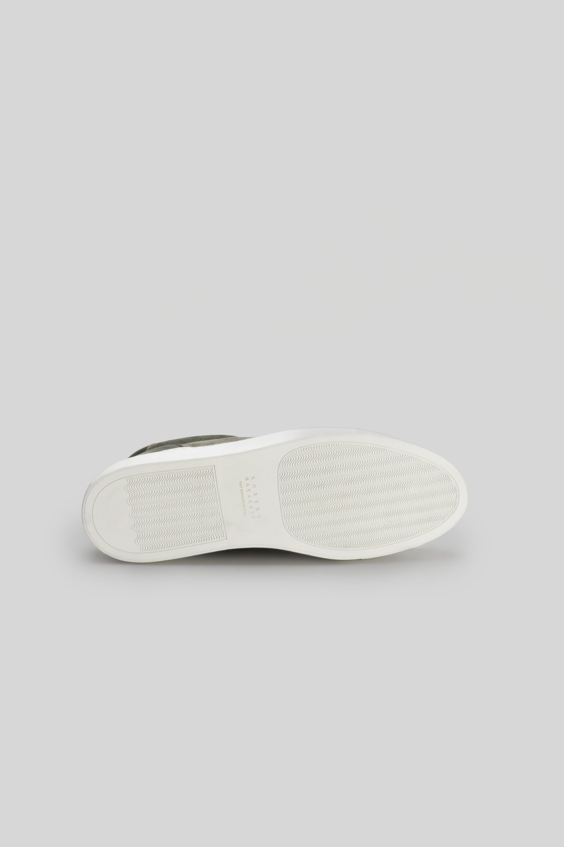 White and gray sneaker sole with textured rubber tread pattern, shown from underneath.