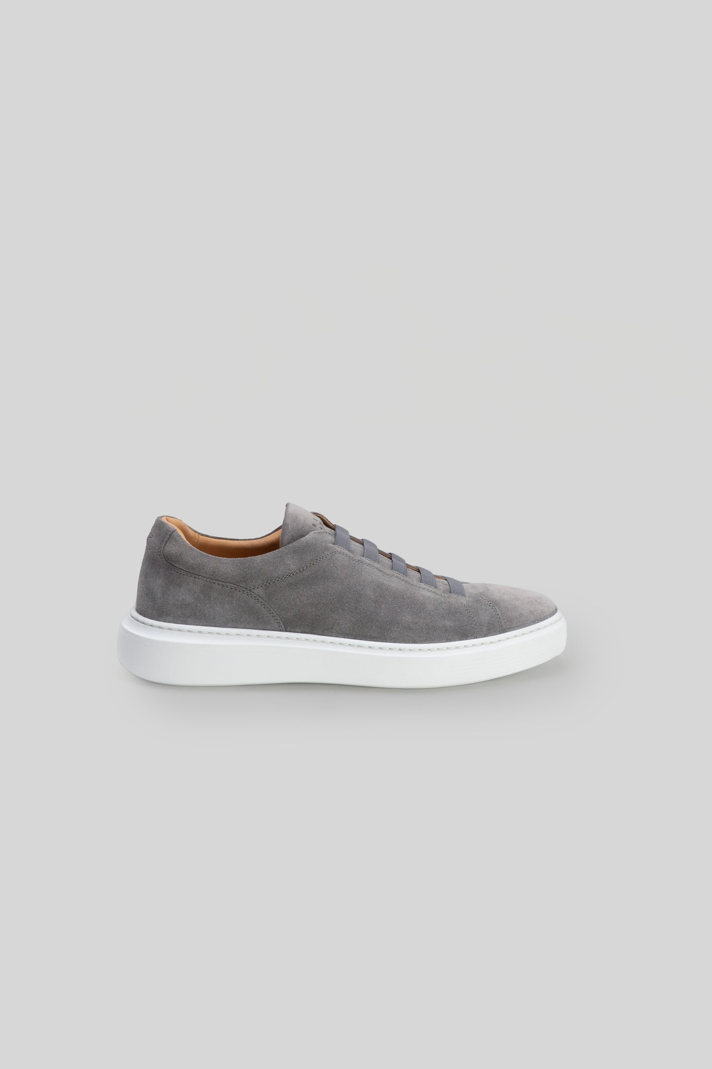 Gray suede sneaker with white sole and tan interior lining, shown in side profile.