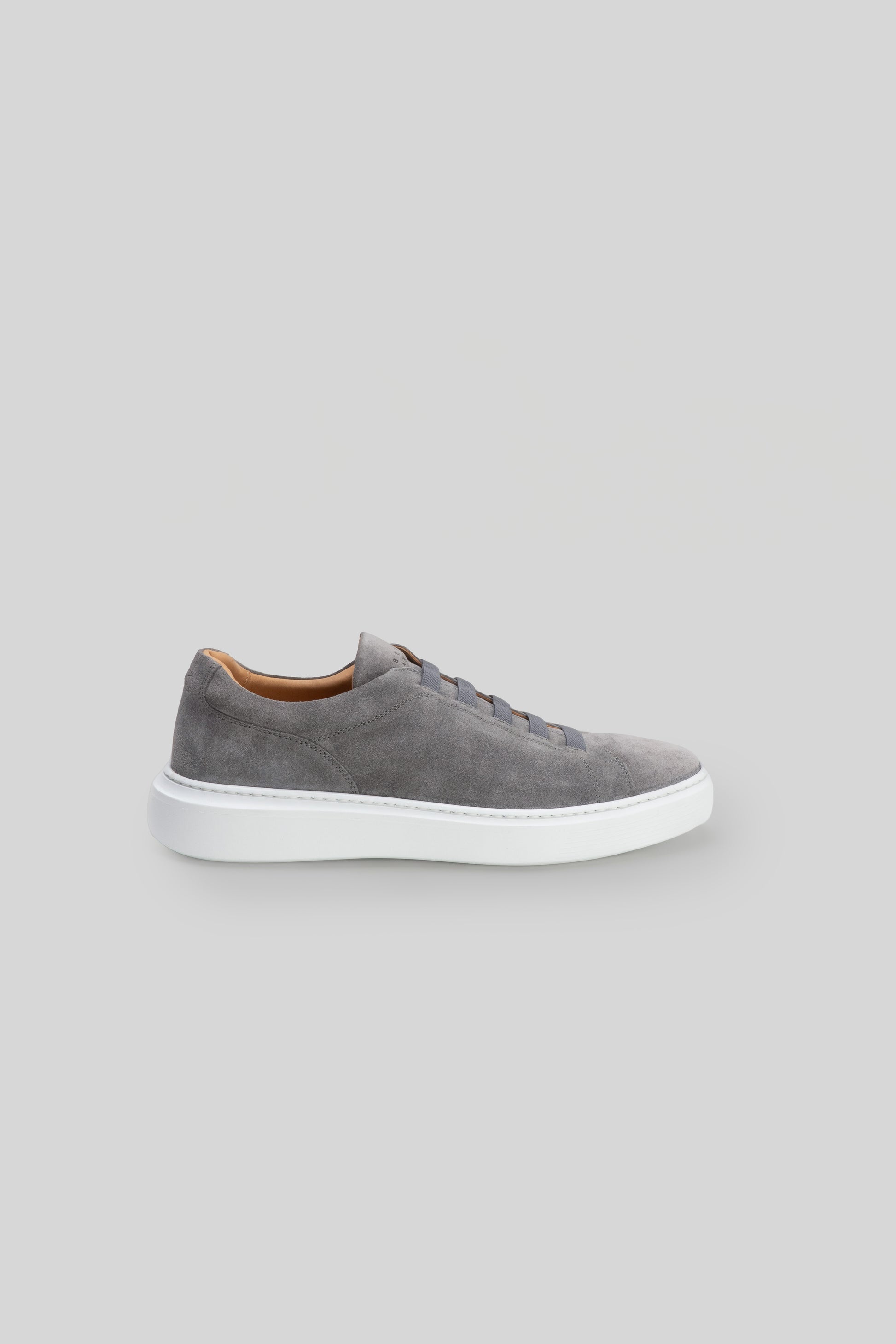 Gray suede sneaker with white sole and tan interior lining, shown in side profile.