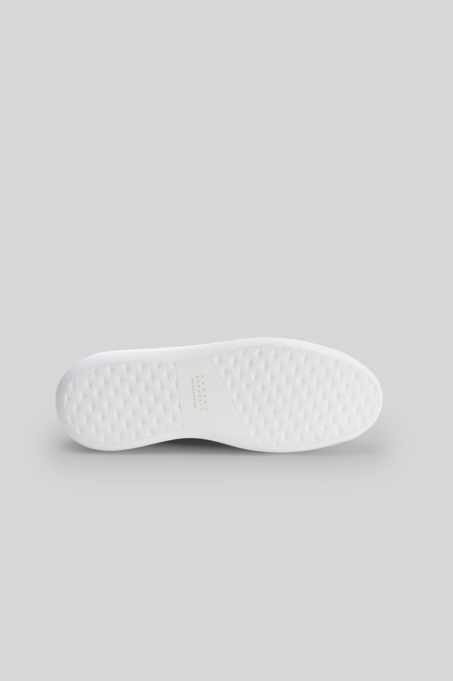 White textured rubber sole of a sneaker viewed from underneath.