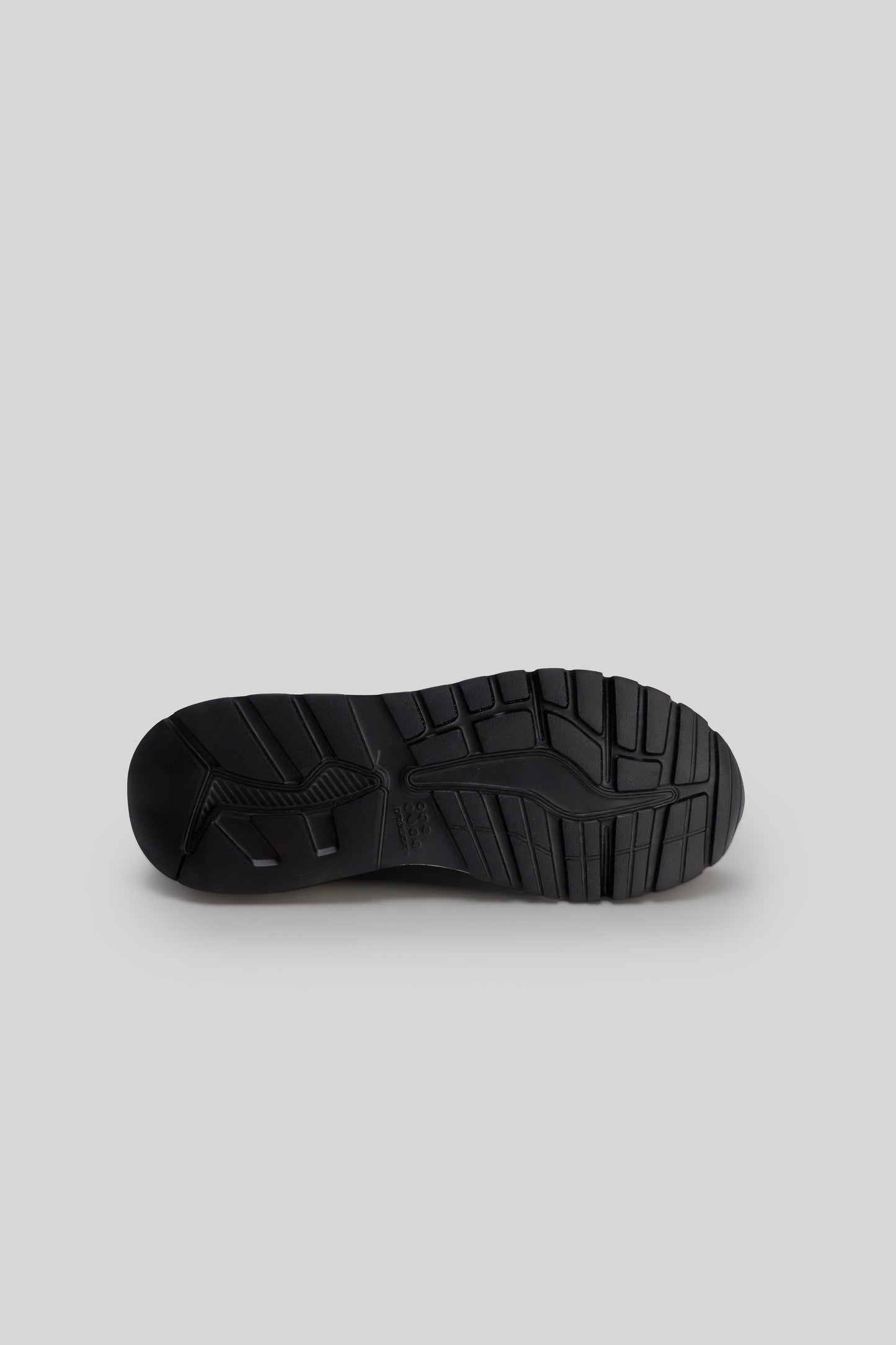 Black knit sneaker sole with tread pattern, shown from bottom view.