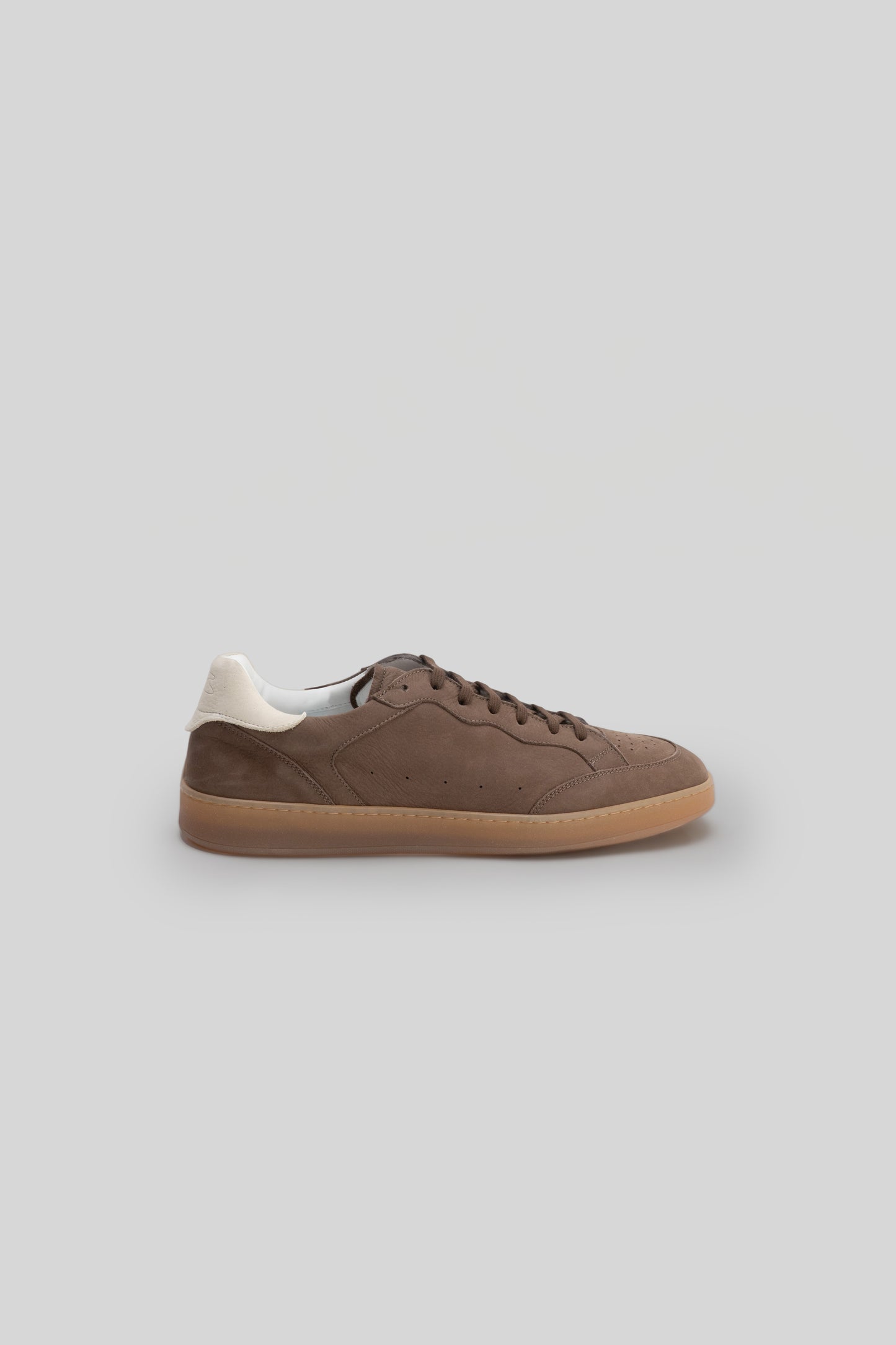Brown suede sneaker with cream heel counter and gum rubber sole, shown in side profile.