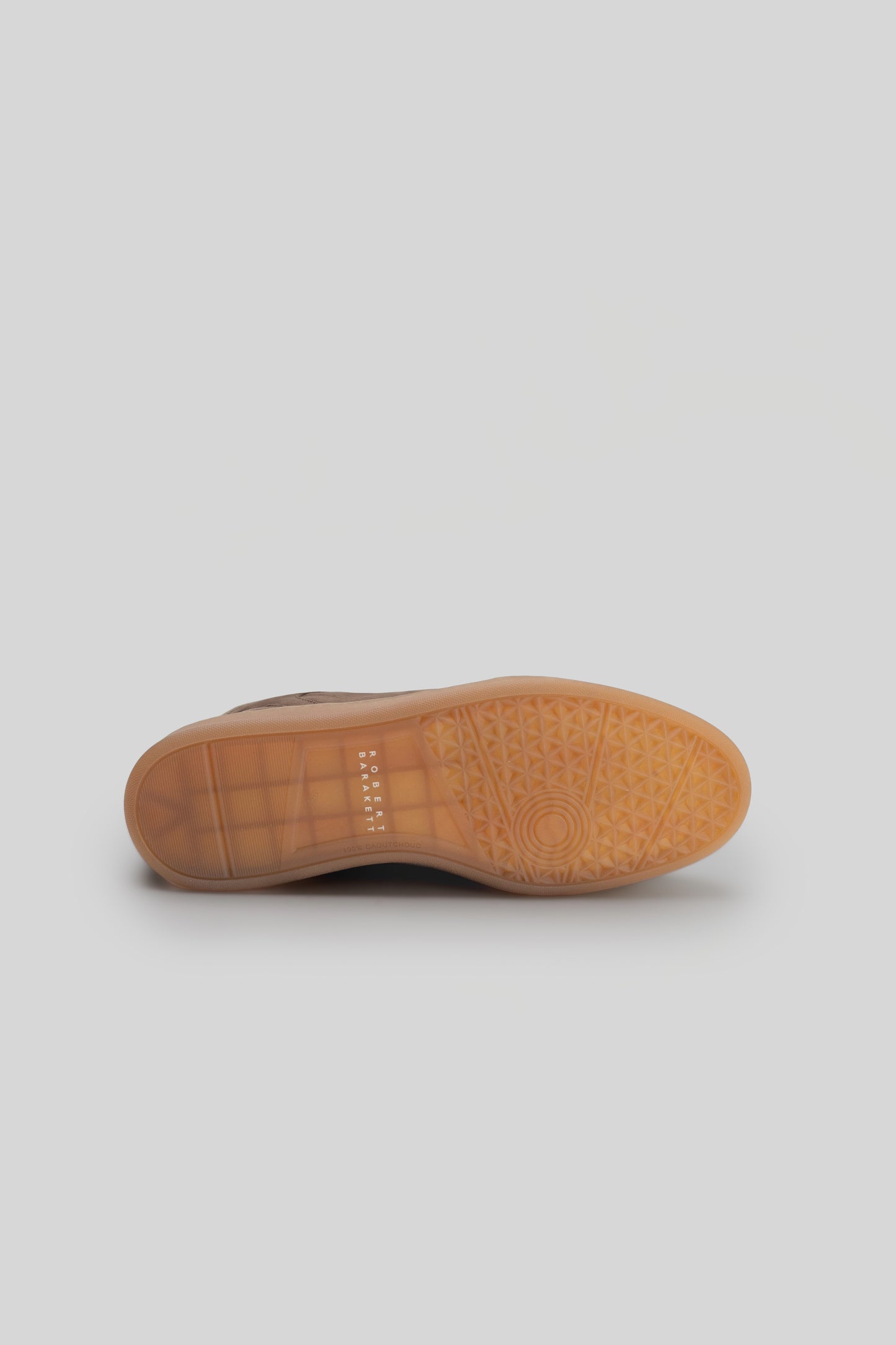 Bottom sole view of Rodney Court Sneaker showing tan rubber outsole with geometric tread pattern and small text detail.