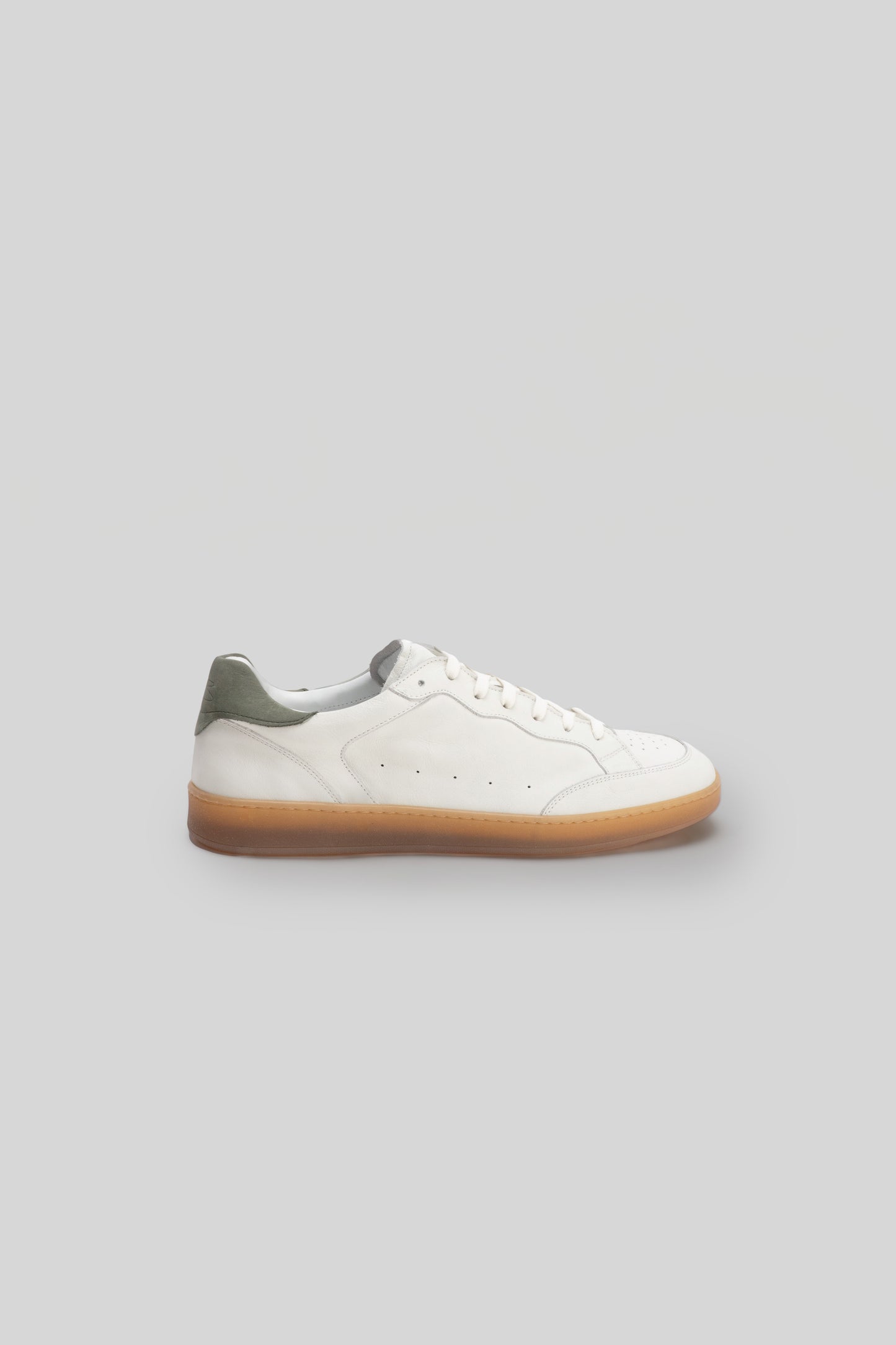 White leather court sneaker with olive green heel collar and gum rubber sole, shown in profile view.