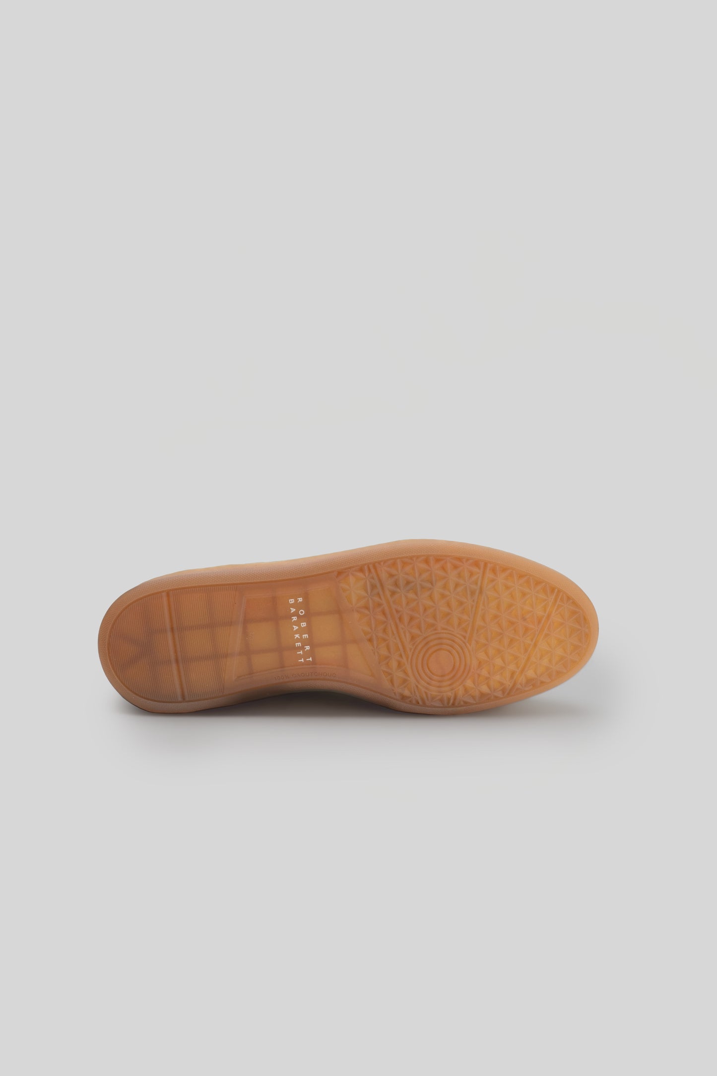 Tan rubber sole with geometric tread pattern and circular design detail.